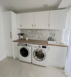 a washer and dryer sitting in a kitchen next to each other on top of a counter