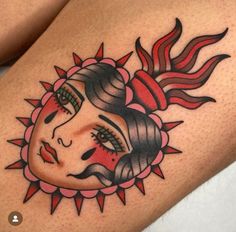 a woman's thigh with a sun tattoo on it