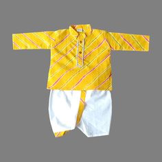 This traditional Indian Pretty Yellow Lahriya Print Gota Work Cotton Dhoti Kurta Pajama For Newborn Baby Dress Infant Traditional Ethnic Wear, will surely add charm to your cute boy. SALES PACKAGE- 1 Kurta, 1 Dhoti ( Pant ) Or Pajama ( Pant ) FABRIC-   100 % Cotton Cloth  OTHER DETAILS- This Product Is Good For Your Baby Skin                                    Best Quality And Quick Dispatch                                    It has a soft elastic belt for convenient fitting on the waist. Delive Fitted Cotton Salwar Kameez For Puja, Yellow Cotton Traditional Wear For Eid, Yellow Cotton Salwar Kameez With Bandhani Print, Yellow Sets With Bandhani Print For Festivals, Festival Yellow Sets With Bandhani Print, Cotton Sets With Bandhani Print In Traditional Drape, Summer Cotton Traditional Wear With Drape, Summer Cotton Traditional Wear With Traditional Drape, Yellow Bandhani Print Kurta For Summer