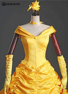 a yellow dress is shown with gloves on it