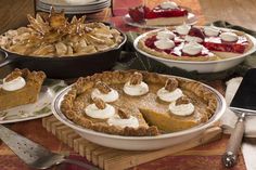 several pies and pie plates on a table