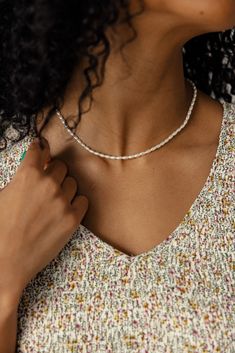 Wrap your neck in shimmering pearls with this lovely pearl choker necklace! It's a dainty piece that adds a touch of elegance to any outfit. Simple, sweet, and oh-so-stylish! 20% brass clasp with 80% acrylic pearls 15.5” long + 2” extender Trendy Pearl Drop Necklace, Dainty Pearl White Beaded Necklaces, Trendy Pearl White Pearl Necklace, Dainty Single Strand Beaded Necklace, Dainty Pearl Beaded Choker Necklace, Dainty Pearl Chain Beaded Necklace, Pearl Choker With Tiny Beads, White Pearl Charm Beaded Necklace, Delicate Beaded Pearl Chain Necklace