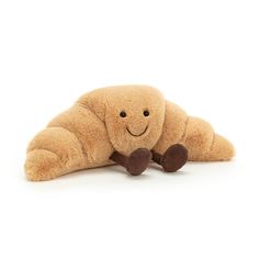 a brown stuffed animal laying on its side