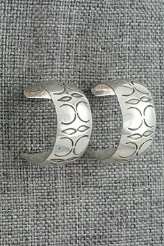 This pair of sterling silver hoop earrings were made by Navajo silversmith Nora Ashley. The backs are signed A and stamped sterling.Length: 3/4"Width: 1/2"Free shipping on all orders! We ship with USPS and always include tracking. All orders ship within a day of payment.Returns are accepted up to 30 days after you receive your order. Just send us a message. Our shop offers cash back or store credit. The item must be returned in new condition. Silver Southwestern Hoop Earrings As Gift, Silver Southwestern Hoop Earrings For Gift, Sterling Silver Hoop Earrings With Oxidized Finish, Southwestern Silver Round Hoop Earrings, Nickel-free Southwestern Hoop Earrings, Southwestern Style Nickel-free Sterling Silver Jewelry, Turquoise Sterling Silver Nickel-free Hoop Earrings, Bohemian Sterling Silver Nickel-free Hoop Earrings, Bear Carving