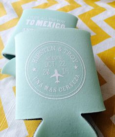 two wedding koozies sitting on top of a yellow and white bed spread with the words mexico destination wedding koozies