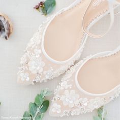 wedding shoes with flowers and leaves on the ground