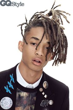 a young man with dreadlocks on top of his head