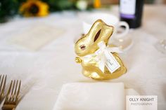 a gold bunny shaped chocolate egg sitting on top of a table