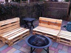 three wooden benches sitting next to each other on top of a brick floored patio