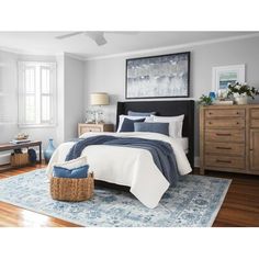 a bedroom with white walls and blue accents