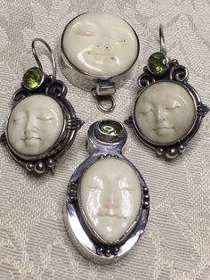 Beautiful handmade sterling silver pendant, earrings and clasp (made by another artist) with carved bone faces and Peridot Stones plus a huge collection of peridot stone beads - nine batches in different sizes, shapes and tones.  Also included are matching green glass beads, seed beads and pearls. The faces are carved from bone and bezel set in sterling silver - marked on the back but hard to see in photos and without a magnifying glass. Also included are off white beads, including some that are Unique Jewelry With Carved Round Beads, Bohemian Carved Round Beads Jewelry, Carved Stone Jewelry, Handmade Artisan Pendant Beads, Gems, And Cabochons, Bohemian Silver Beads, Gems, And Cabochons With Stones, Rhodochrosite Necklace, Handmade Artisan Green Beads, Gems, And Cabochons, Moon Face, Carved Bone