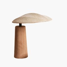 a wooden table lamp on a white background with the light turned off to show it's natural wood structure