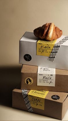 three boxes stacked on top of each other with different types of pastries in them