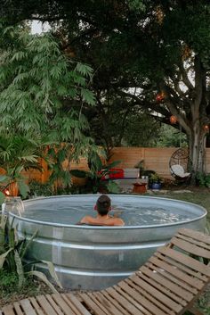 a person sitting in an outdoor hot tub