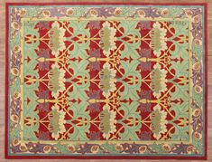 a red and green rug with floral designs on the bottom, in an ornate pattern