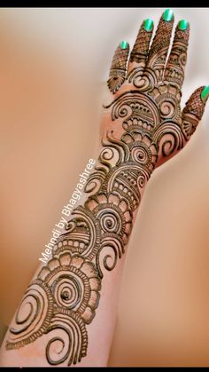 a woman's hand with henna tattoos on it