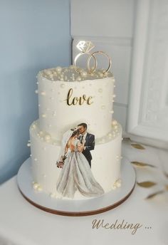 a wedding cake with the bride and groom's photo on top is decorated with pearls