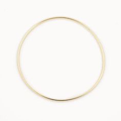 14k gold plated Sterling Silver 63cm inner diameter  1.8mm width  Our gold bangles are a classic and dainty piece of jewellery that is a staple to everyone's jewellery collection. Whether you wear it as a stand alone statement piece or later it with 2 or 3 bangles and even add some bracelets. These bangles make the perfect gift for yourself or someone special and comes packaged in a beautiful box. 14k Gold Circular Jewelry, Minimalist Yellow Gold Hoop Bracelet, Everyday Gold Full Circle Jewelry, Minimalist Circle Gold Jewelry, Everyday Full Circle Gold Jewelry, Minimalist 14k Gold Hoop Bangle, Minimalist Yellow Gold Brass Bangle, Minimalist Gold Hoop Bracelet, Minimalist 14k Gold Bangle Jewelry