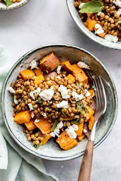 two bowls filled with food on top of a table