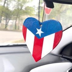 a patriotic heart hanging from the side of a car