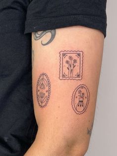 a person with a tattoo on their arm and some flowers in the frame behind them