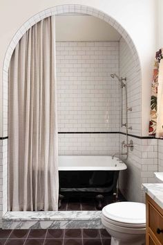 a bath room with a toilet and a bath tub