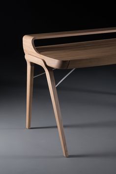 a wooden desk sitting on top of a gray floor