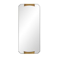 a mirror that is on top of a white surface with gold trimmings and an oval