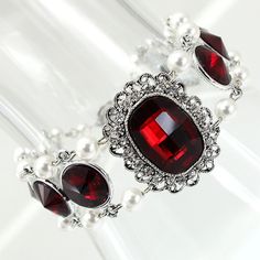 Red Crystals attractive and elegant bracelet for every women who desires to look beautiful and attractive. Perfect for your wedding or common wear. The faceted round Siam Czech Crystals Glass 12 mm in a silver rhodium plated base are paired with delicate antique silver plated metal filigree connector (31 mm x 25 mm)with Siam Red Crystal Glass studded with Clear Crystal Glass and round White Premium Quality Crystal Pearls. All metal components are silver plated. The bracelet measures 7 1/2" inclu Red Crystal Bracelet For Wedding, Elegant Red Crystal Bracelet For Weddings, Elegant Red Crystal Wedding Bracelet, Red Bracelets With Intricate Design, Red Crystal Jewelry, Victorian Gothic Jewelry Red, Crystal Jewelry Necklaces, Red Chandelier, Gothic Bracelet