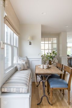 a dining room table with two chairs and a bench