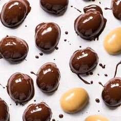 chocolate covered candies are arranged on a sheet of white paper and lined with melted chocolate