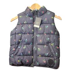 Nwt Gap Kids Medium Puffer Vest - Navy With Flowers Sherpa-Lined Puffer Vest. Water-Resistant Outer Shell. Mockneck. Sleeveless. Zipper Front. Front Slant Pockets. Made With 40% Recycled Polyester Shell. Playful Spring Outdoor Outerwear, Spring Blue Outerwear From Gap, Cute Outerwear For Cold Spring Weather, Cute Gap Cotton Outerwear, Cute Cotton Outerwear By Gap, Cute Gap Outerwear For Fall, Flowers Color, Gap Jacket, Gap Jackets