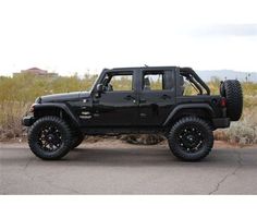 a black jeep parked on the side of a road