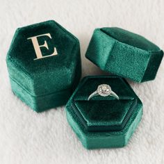 an engagement ring in a velvet box with the initials e and f written on it