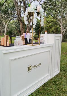 an outdoor bar with flowers and candles on it