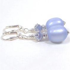 "Earrings are made with vintage moonglow lucite beads in a pastel periwinkle blue color. Moonglow lucite has an inner glowy style effect as you move around in the light. Perfect for Spring wear. Available in hook, lever back, or clip on style. Size: Drop length is 1 1/4\".  Type: New, Handmade by Sharky. Condition: Vintage beads used are new old stock that were never before used. Materials: Lucite, silver plated metal, glass." Floral Cuff, Periwinkle Blue, Moon Glow, Black Enamel, Cuff Bracelet, Jewelry Pieces, Silver Plate, My Jewellery, Jewelry Box