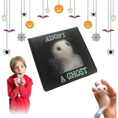 a child holding a toy in front of a book with an image of a ghost on it