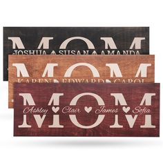 three wooden signs with the words mom and two children's names in different colors