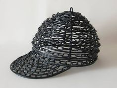 a hat made out of black wire on a white background