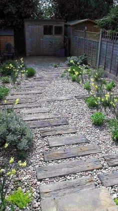 a stone path in the middle of a garden