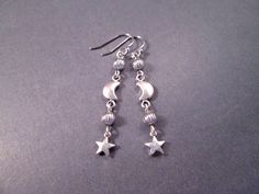 Silver star charms (6mm) and 6x9mm crescent moons, with silver accent beads and french hook ear wires. These earrings measure just under two and 1/4 inches in length.... See more of my designs here; justEARRINGS.etsy.com More Moon/Sun/Star earrings here: https://www.etsy.com/shop/justEARRINGS?ref=simple-shop-header-name&listing_id=98153476&section_id=38062962 And please visit my sister~shops; justCHARMING.etsy.com & BohoDreamJewelry.etsy.com All of my jewelry shops offer FREE SHIPPING! Highlight Black Art Prints, Moon Sun Star, Star Earrings Silver, Silver Star Earrings, Moon And Star Earrings, Crescent Moon Earrings, Crescent Moon Pendant, Moon Sun, Silver Dangle Earrings