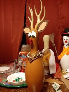 a table topped with fake reindeer heads and other decorations