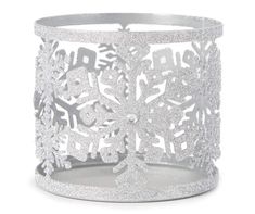 a silver cuff with snowflakes and stars on the inside, in front of a white background