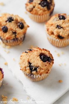 several blueberry muffins on a white tray