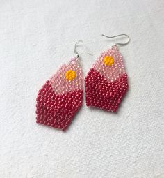 These darling seed bead earrings feature a mountain scene gradient of red and pink inspired by the beautiful Rocky Mountains. They hang approximately 1.75 inches from the lobe and measure 1 inch across their widest point. Beads and Earwires: Each pair is handmade with the highest quality size 11 Miyuki Delica beads. The closure is a sterling silver finding. If you have specific sensitivities I can make your earrings with gold plated findings, just let me know! Packaging: All earrings are individ Bead Cap Drop Earrings As Gift, Bead Caps Drop Earrings As Gift, Bead Cap Drop Earrings For Gift, Pink Teardrop Jewelry Beads For Crafting, Pink Teardrop Beads For Jewelry Crafting, Teardrop Pink Jewelry For Crafting, Pink Beaded Dangle Earrings With Bead Caps, Pink Dangle Beaded Earrings With Bead Caps, Pink Beaded Earrings With Bead Caps As Gift