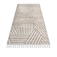 a beige and white rug with tassels on the bottom, in front of a white background