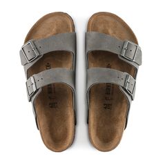 An icon of timeless design and legendary comfort, the Arizona sandal has been defining style since 1973. Grained nubuck leather brings distinct character to the classic, two-strap look. Complete with legendary BIRKENSTOCK design elements, like a contoured cork-latex footbed for the ultimate in support. Contoured cork-latex footbed creates custom support with wear Grained nubuck leather upper Suede footbed lining helps keep you comfortable EVA sole is flexible and lightweight Two adjustable strap Classic Leather Sandals For Outdoor, Classic Sandals With Leather Footbed For Outdoor, Classic Suede Sandals With Cushioned Footbed, Classic Suede Sandals With Leather Sole, Classic Suede Sandals, Birkenstock Sandals Arizona, Birkenstock Arizona, Eva Sole, Metal Pins