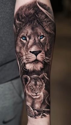 a man's arm with a lion and cub tattoo on it, which has blue eyes