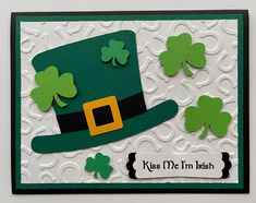 a st patrick's day card with shamrocks and a hat