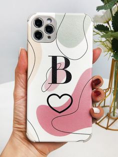 a person holding up a phone case with an i love design on the front and back